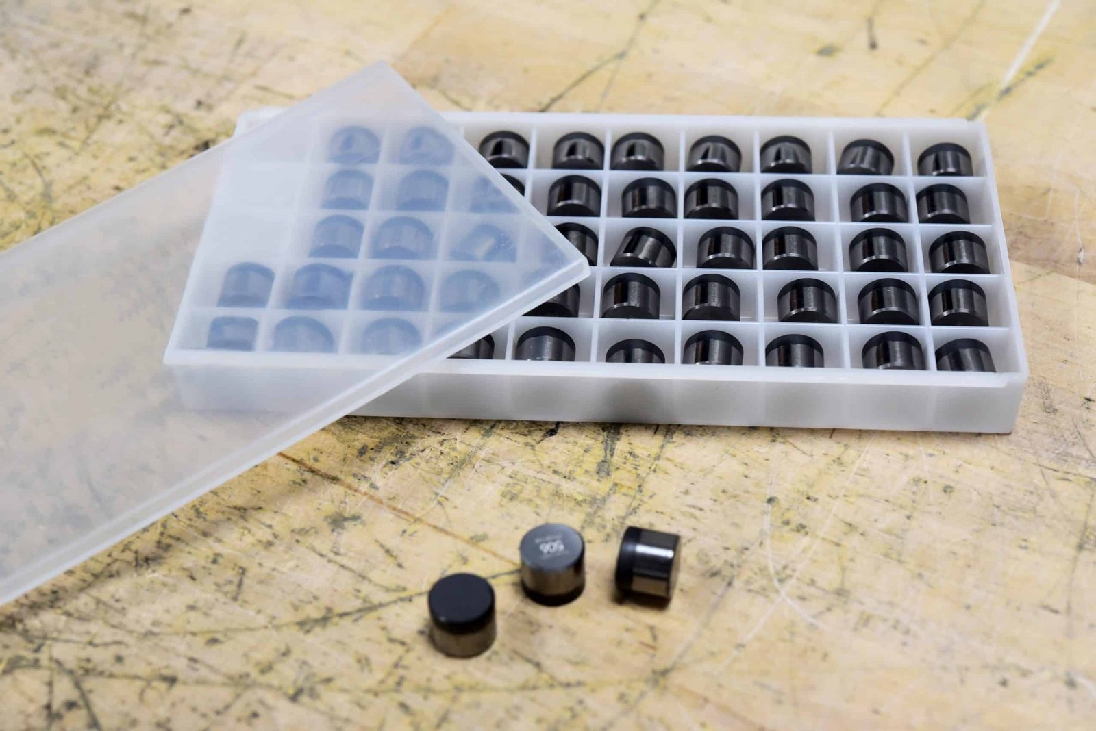 Drillexa Omega cutters in plastic container on table