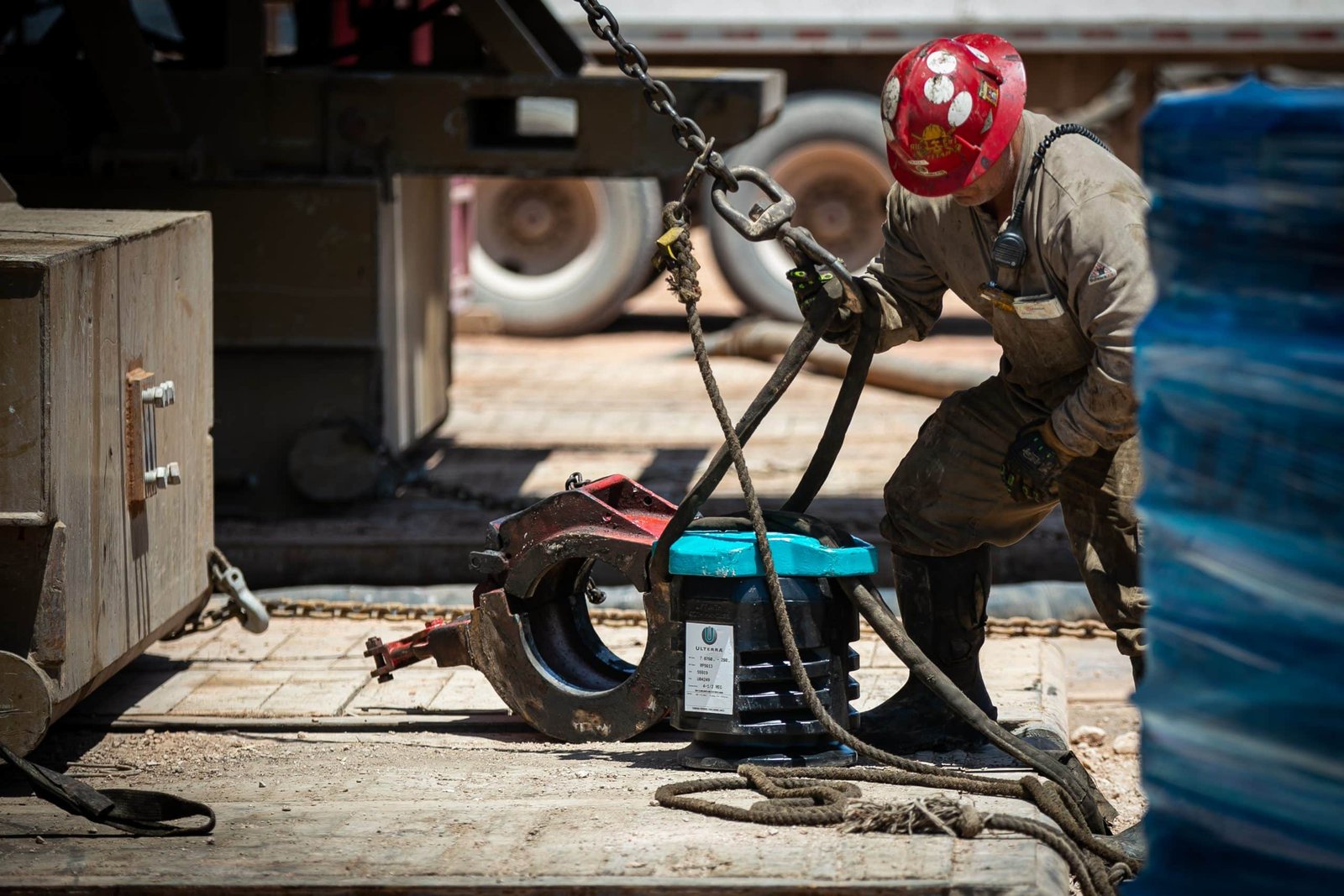 Worker in rig gear ready to install a new high-performance RipSaw PDC bit still in its case 